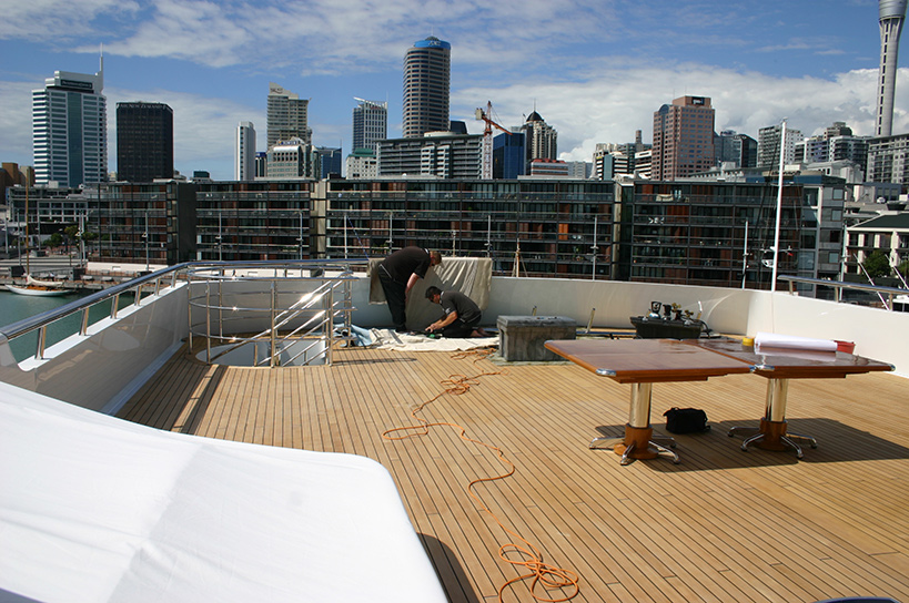 Image showing Contab International workers installing a stainless steel balustrade on the deck of a super yacht.