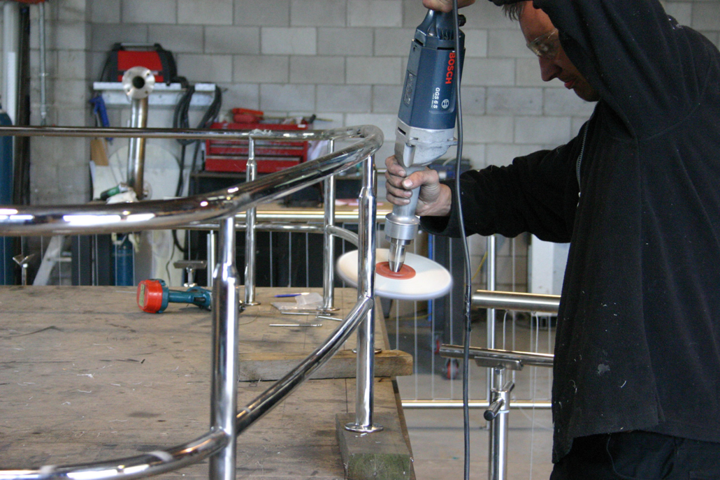 image of a man polishing stainless steel marine railings